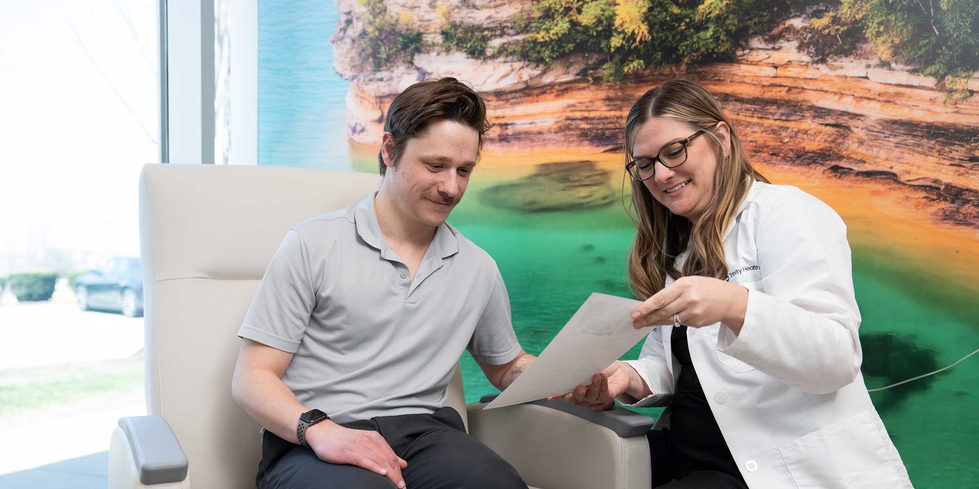 A man meets with his provider about infusion therapy